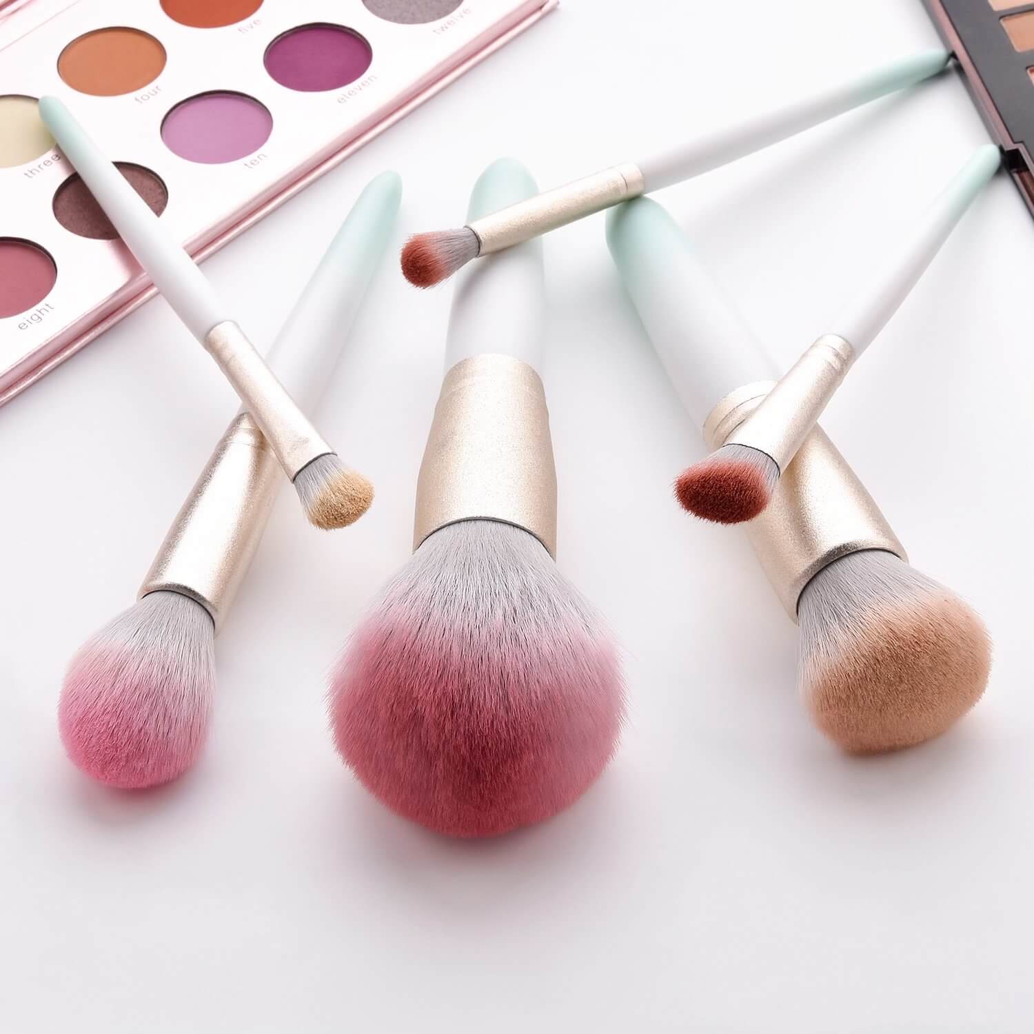 Makeup brushes lying with eyeshadow palette