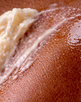 Close up of Swept Away Body Butter melting on skin.