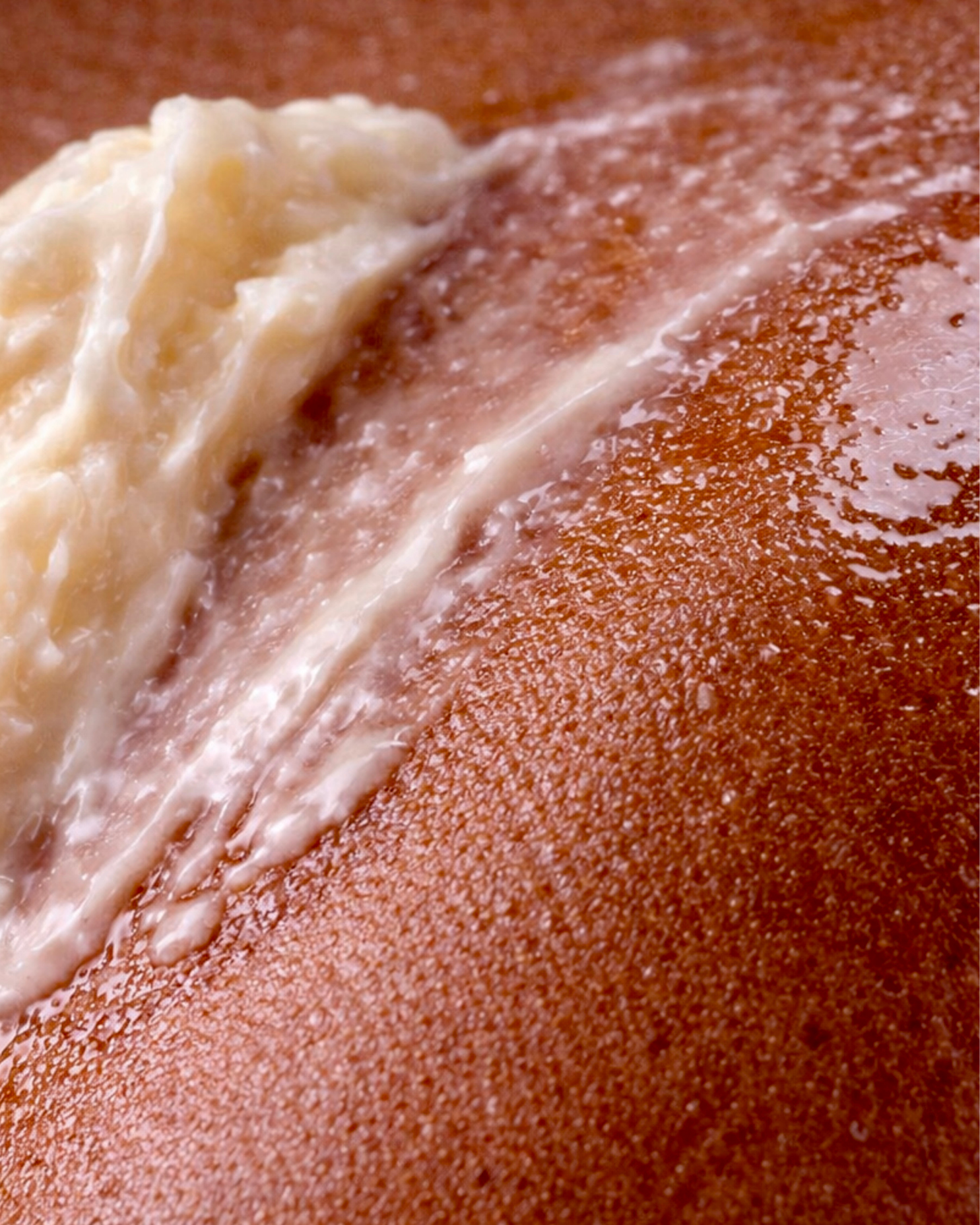 Close up of Swept Away Body Butter melting on skin.
