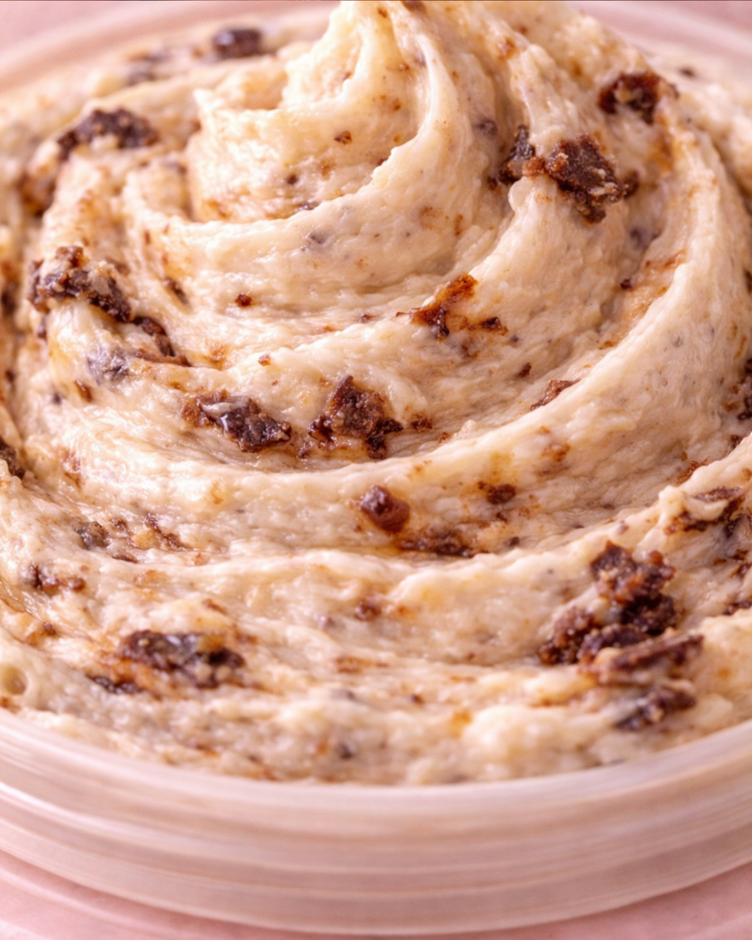 Close-up of a swirl of creamy Cookie Monsta Body Butter with chocolate chips.