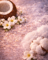 Coconut, cotton, and white flowers on a textured surface