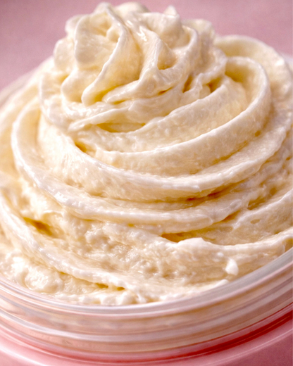 Close-up of a swirl of Swept Away Body Butter in a pink container on a pink background