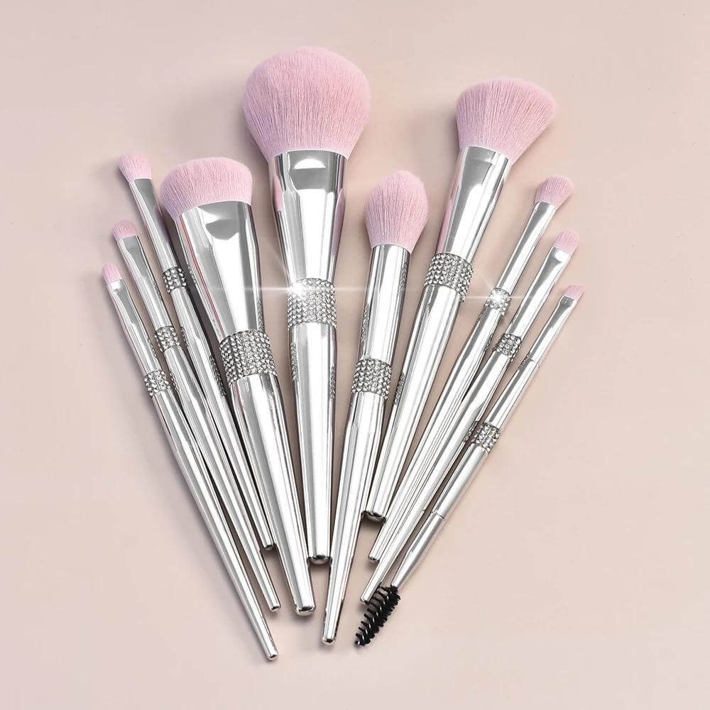 11 pc. Silver metallic makeup brushes with pink bristles and rhinestone detail Fanned out