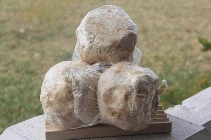 Three balls of African white soap wrapped