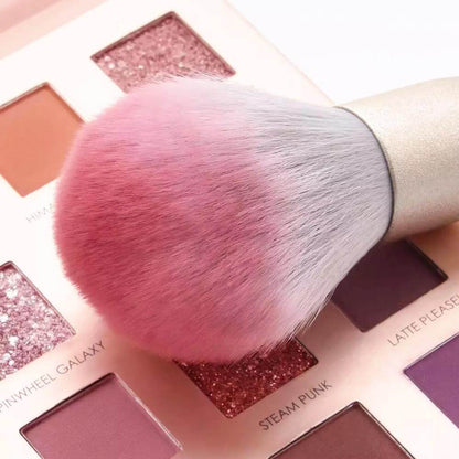 Makeup brush dipped in eyeshadow palette
