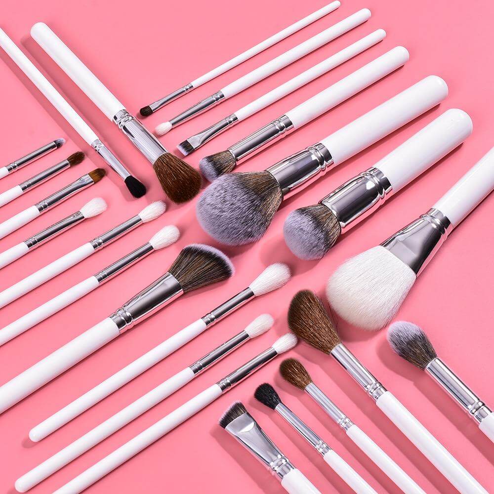 15 pc. Sleek Contours Makeup Brushes with white handles and aluminum ferrule spread out on display