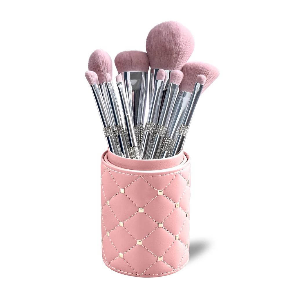 11 pc. Silver metallic makeup brushes with pink bristles and rhinestone detail Inside cylinder case