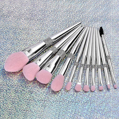 11 pc. Silver metallic makeup brushes with pink bristles lying down
